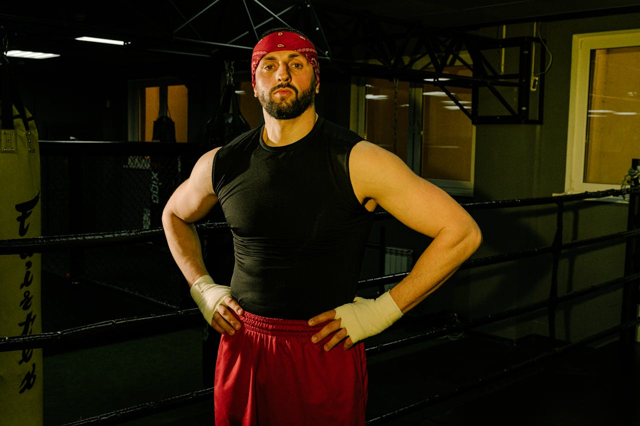 Professional wrestling athlete standing in a training ring preparing for a wrestling match during gym training session